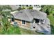 Aerial view of the back patio, with a roof and columns, plus an AC unit and storage shed at 751 Meandering Way, Polk City, FL 33868