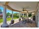 Inviting back porch with ceiling fans, perfect for outdoor dining and entertaining at 751 Meandering Way, Polk City, FL 33868