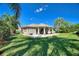 Lush backyard featuring a covered patio, perfect for outdoor living and entertainment at 751 Meandering Way, Polk City, FL 33868