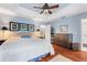 A bright bedroom showcases hardwood floors, a king bed, and light blue walls at 751 Meandering Way, Polk City, FL 33868