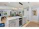 Open kitchen featuring an island and stainless steel appliances, opening up to the living room at 751 Meandering Way, Polk City, FL 33868