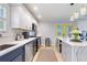 Well-lit kitchen with stainless steel appliances and a breakfast bar, with a bright yellow door at 751 Meandering Way, Polk City, FL 33868