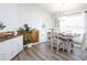 Bright dining room with white farmhouse table and chairs, wood accent wall at 7602 Sw 107Th Ln, Ocala, FL 34480