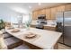 Modern kitchen with large island, stainless steel appliances, and white countertops at 7602 Sw 107Th Ln, Ocala, FL 34480