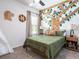 bedroom with safari theme, including tree mural and stuffed animals at 7621 Sw 107Th Ln, Ocala, FL 34480