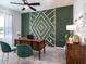 Stylish home office features a geometric wall design, wood desk, and green velvet chairs at 7621 Sw 107Th Ln, Ocala, FL 34480