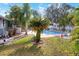 Relaxing backyard with a sparkling pool surrounded by tropical plants at 813 Heron Pl, Winter Haven, FL 33884