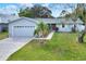 Single-story home with attached garage and well-maintained lawn at 813 Heron Pl, Winter Haven, FL 33884