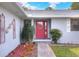 Inviting front entrance with red door and landscaped walkway at 813 Heron Pl, Winter Haven, FL 33884