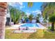 Inviting swimming pool with a tranquil fountain and lush landscaping at 813 Heron Pl, Winter Haven, FL 33884