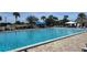 Community pool with plenty of lounge chairs and umbrellas at 8655 Sw 98Th Street Rd # A, Ocala, FL 34481