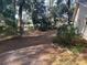 Large side yard with mature trees and gravel at 8655 Sw 98Th Street Rd # A, Ocala, FL 34481