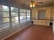 Bright sunroom with large windows, built in shelving, and tile flooring at 8655 Sw 98Th Street Rd # A, Ocala, FL 34481