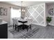 Bright dining room features a marble table, six chairs, and an accent wall at 8960 Se 44Th Ct, Ocala, FL 34480