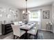 Modern dining room with marble table, white chairs, and decorative wall art at 8960 Se 44Th Ct, Ocala, FL 34480