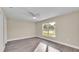 Spacious bedroom with large window, ceiling fan, and wood-look flooring at 1029 Lakewood Ct, Lakeland, FL 33801