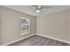 Bright bedroom with ceiling fan and grey vinyl flooring at 1029 Lakewood Ct, Lakeland, FL 33801