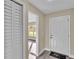 Bright entryway with white louvered doors and wood-look flooring at 1029 Lakewood Ct, Lakeland, FL 33801