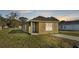 Tan house with gray roof, small lawn, and driveway at 1029 Lakewood Ct, Lakeland, FL 33801