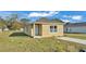 Newly constructed light brown home with a concrete driveway and grassy yard at 1029 Lakewood Ct, Lakeland, FL 33801