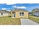 Tan house with gray roof and small lawn at 1029 Lakewood Ct, Lakeland, FL 33801