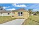 Tan house with gray roof and small lawn at 1029 Lakewood Ct, Lakeland, FL 33801