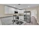 Modern kitchen with white cabinets, stainless steel appliances, and granite counters at 1029 Lakewood Ct, Lakeland, FL 33801