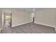Open living room featuring wood-look floors and a view into the kitchen at 1029 Lakewood Ct, Lakeland, FL 33801