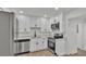 Bright kitchen featuring modern appliances, white cabinets, and stylish countertops at 1038 Canal E Dr, Lakeland, FL 33801