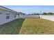 Spacious backyard featuring green lawn with perimeter fencing, offering a private outdoor space at 1065 Silas St, Haines City, FL 33844