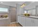 Spacious bathroom with a double vanity, tiled shower, and modern fixtures at 1065 Silas St, Haines City, FL 33844