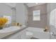 Well-lit bathroom featuring a tub and shower combination, vanity, and neutral tile at 1065 Silas St, Haines City, FL 33844