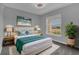 Cozy bedroom with a queen bed, complemented by natural lighting and modern decor at 1065 Silas St, Haines City, FL 33844