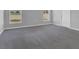 Bedroom with neutral-colored carpet, two windows and a door at 1065 Silas St, Haines City, FL 33844