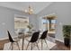 Bright dining room with modern table, chandelier, and sliding glass doors to the outdoor area at 1065 Silas St, Haines City, FL 33844