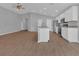 Bright, open kitchen and living area featuring a large island with seating and stainless appliances at 1065 Silas St, Haines City, FL 33844