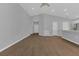 Open-concept living area with wood-look flooring and abundant natural light at 1065 Silas St, Haines City, FL 33844