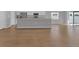 Expansive open-concept layout showcasing a modern kitchen, a large island, and stylish wood flooring at 1065 Silas St, Haines City, FL 33844