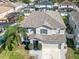 Two-story house, gray roof, and a landscaped yard with palm trees at 1074 Berkeley Dr, Kissimmee, FL 34744