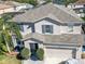 Two-story house with gray siding, a two-car garage, and a landscaped yard at 1074 Berkeley Dr, Kissimmee, FL 34744