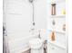 Clean bathroom with shower, toilet, vanity, and white shelving at 1074 Berkeley Dr, Kissimmee, FL 34744