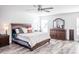 King-size bed, wood dresser, and ceiling fan at 1074 Berkeley Dr, Kissimmee, FL 34744