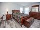 Main bedroom with wood floors, large bed, and ample storage at 1074 Berkeley Dr, Kissimmee, FL 34744