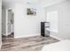 Bedroom with mini-fridge, en-suite bathroom, and wood-look floors at 1074 Berkeley Dr, Kissimmee, FL 34744