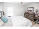 Bedroom with queen bed, dresser, and wood-look floors at 1074 Berkeley Dr, Kissimmee, FL 34744