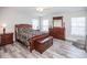 Main bedroom with wood floors, large bed, and ample storage at 1074 Berkeley Dr, Kissimmee, FL 34744