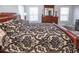 Main bedroom with wood floors, large bed, and ample storage at 1074 Berkeley Dr, Kissimmee, FL 34744