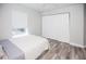 Bright bedroom with a queen bed, large closet, and wood-look floors at 1074 Berkeley Dr, Kissimmee, FL 34744