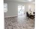 Bright dining room with wood-look tile floors and sliding glass doors leading to the pool at 1074 Berkeley Dr, Kissimmee, FL 34744