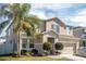 Two-story house with gray siding, gray shutters, and a two-car garage at 1074 Berkeley Dr, Kissimmee, FL 34744